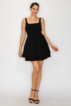 Load image into Gallery viewer, Woman wearing a black dress against a white background
