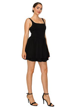 Load image into Gallery viewer, Woman wearing a black dress against a white background
